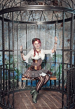 Beautiful steampunk woman in the cage