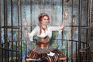 Beautiful steampunk woman in the cage