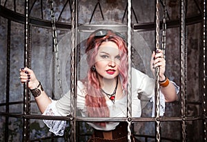 Beautiful steampunk woman in the cage