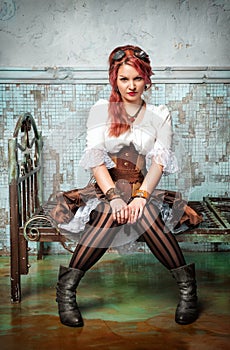 Beautiful steampunk woman on the metal bed