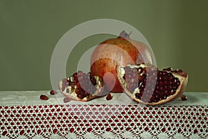 beautiful still life with pomegranate on a table with lace photo
