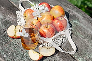 A beautiful still life with ripe apples and branches with white flowers. Zero waste concept