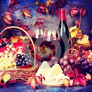 Beautiful still life with wine glasses, grapes, pomegranate and