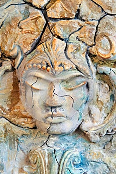 Beautiful stone face sculpture with a closed eyes