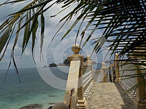 Beautiful stone stairs with the ocean in the background, on the beach of Pulau Kapas island photo
