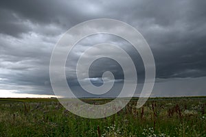 Beautiful storm sky with clouds and field