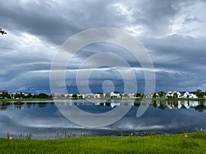 Beautiful stormy cloudy sky reflecting on a lake.