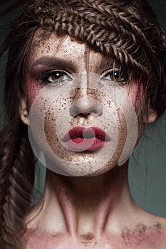 Beautiful strange girl with creative art make-up. Beauty face.
