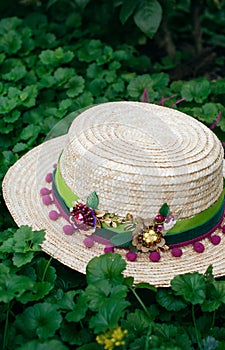 Beautiful straw boater decorated with a brooch in green leaves