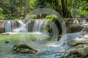 Beautiful stream waterfall run on the rocks in the jungle