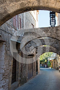 Beautiful street with arches at Rhodes old town, Greece