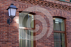 A beautiful street lamp on a red brick wall