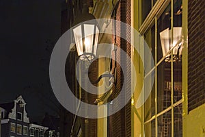 Beautiful street lanterns illuminated at night on wall of house