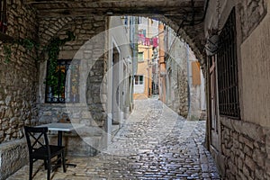 beautiful street of Rovinj Croatia with cobblestone looking through an arch tunel