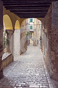 beautiful street of Rovinj Croatia with cobblestone looking through an arch tunel photo