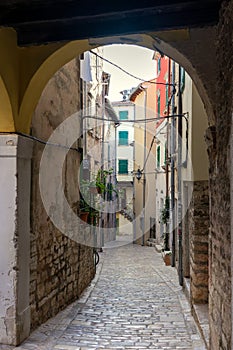 beautiful street of Rovinj Croatia with cobblestone looking through an arch tunel