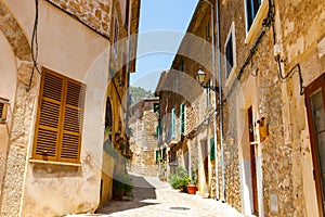 Beautiful street in Valldemossa with traditional flower decoration, famous old mediterranean village of Majorca