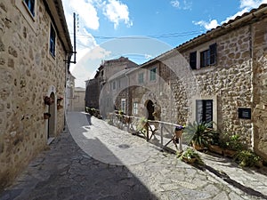 Beautiful street in Valldemossa with traditional flower decoration, famous old mediterranean village of Majorca Spain