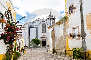 Beautiful street of Ãâbidos and Saint Peter church photo