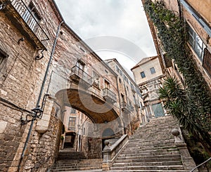 Beautiful streets of Girona old town with ancient buildings and cobblestone stairways, Spain photo