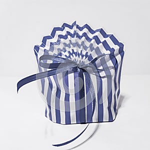 Beautiful striped packing bag tied with a blue ribbon with a bow. Gift wrap. Nice gift, surprise.