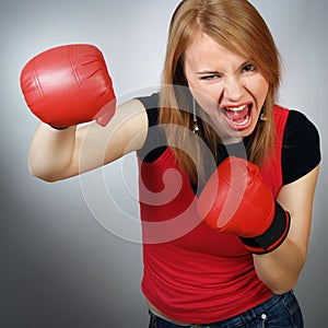 Beautiful strong girl in red gloves for boxing