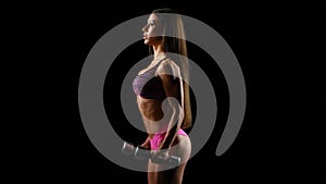 Beautiful strong woman exercises with dumbbells on black
