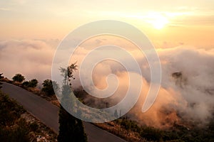 Beautiful structure of clouds on sky, mountain landscape with dense fog at sunset on horizon of beauty natural environment.