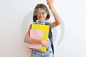 Beautiful student child girl wearing backpack glasses books over isolated white background annoyed and frustrated shouting with