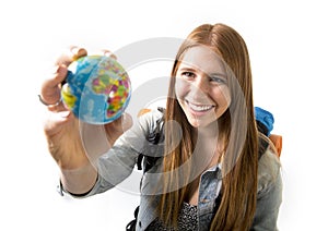 Beautiful student girl holding little world globe in her hand choosing holidays destination in travel tourism concept