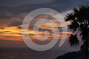 Beautiful, stunning panoramic view of the golden sky and reflections on the Andaman sea during the sunset at Promthep Cape