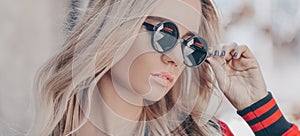 Beautiful stylish blonde woman in black sunglasses in outdoor. Banner photo