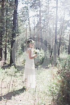 Beautiful stylish bride in the forest