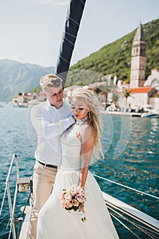 Beautiful stylish bride and groom on the luxury yacht sailing do
