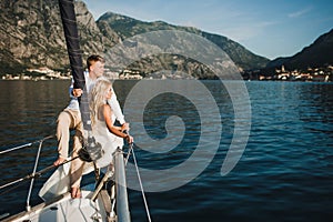 Beautiful stylish bride and groom on the luxury yacht sailing do