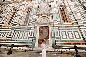 A beautiful stylish bride with an umbrella walks through the old city of Florence.Model with umbrellas in Italy.Tuscany