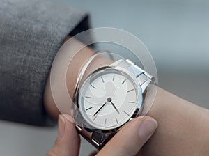 Beautiful stylish classic white watch on woman hand. Close-up photo