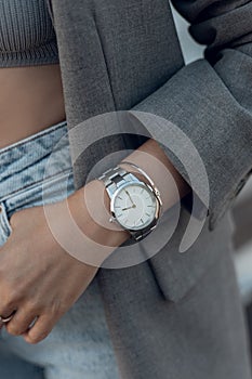 Beautiful stylish classic white watch on woman hand. Close-up photo