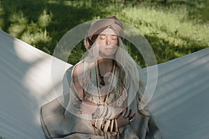 Beautiful stylish countryside woman on the hammock close up