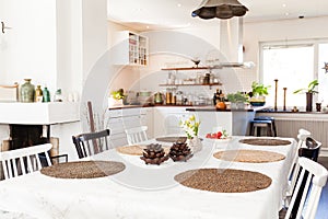 Beautiful stylish diner table with kitchen in the background