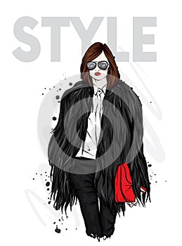 Beautiful stylish girl in a fur coat, trousers and glasses. Fashionable clothes and accessories. Fashion