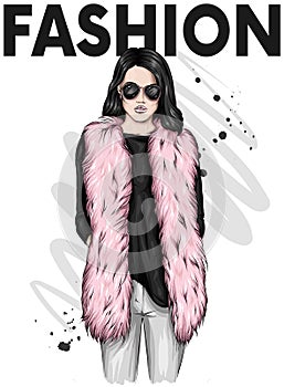 Beautiful stylish girl in a fur coat, trousers and glasses. Fashionable clothes and accessories. Fashion & Style.