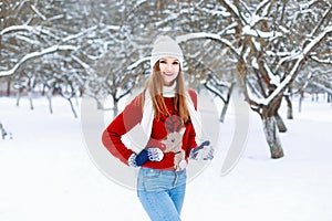 Beautiful stylish girl in a knitted cap, red sweater with a deer