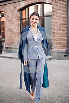 Beautiful stylish lady in blue coat and heels.