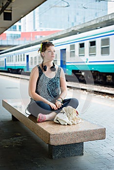 Beautiful stylish modern young woman waiting train