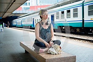 Beautiful stylish modern young woman waiting train