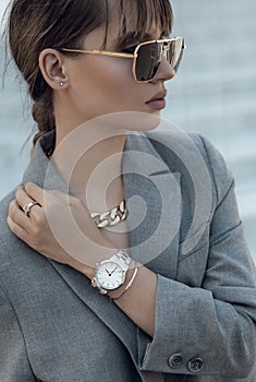 Beautiful stylish white watch on woman hand. Portrait of beautiful woman with stylish silver watch on woman hand