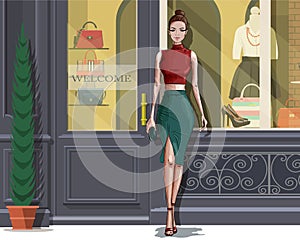 Beautiful stylish woman with boutique facade background.