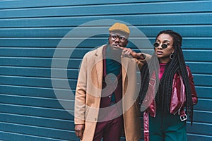 beautiful stylish young african american couple looking away while standing