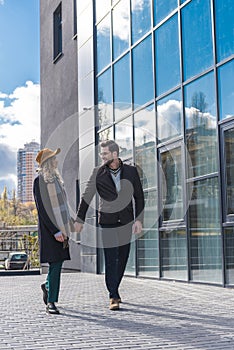 beautiful stylish young couple in autumn outfit walking together